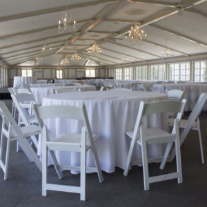 Tables, chairs and white linen overlays